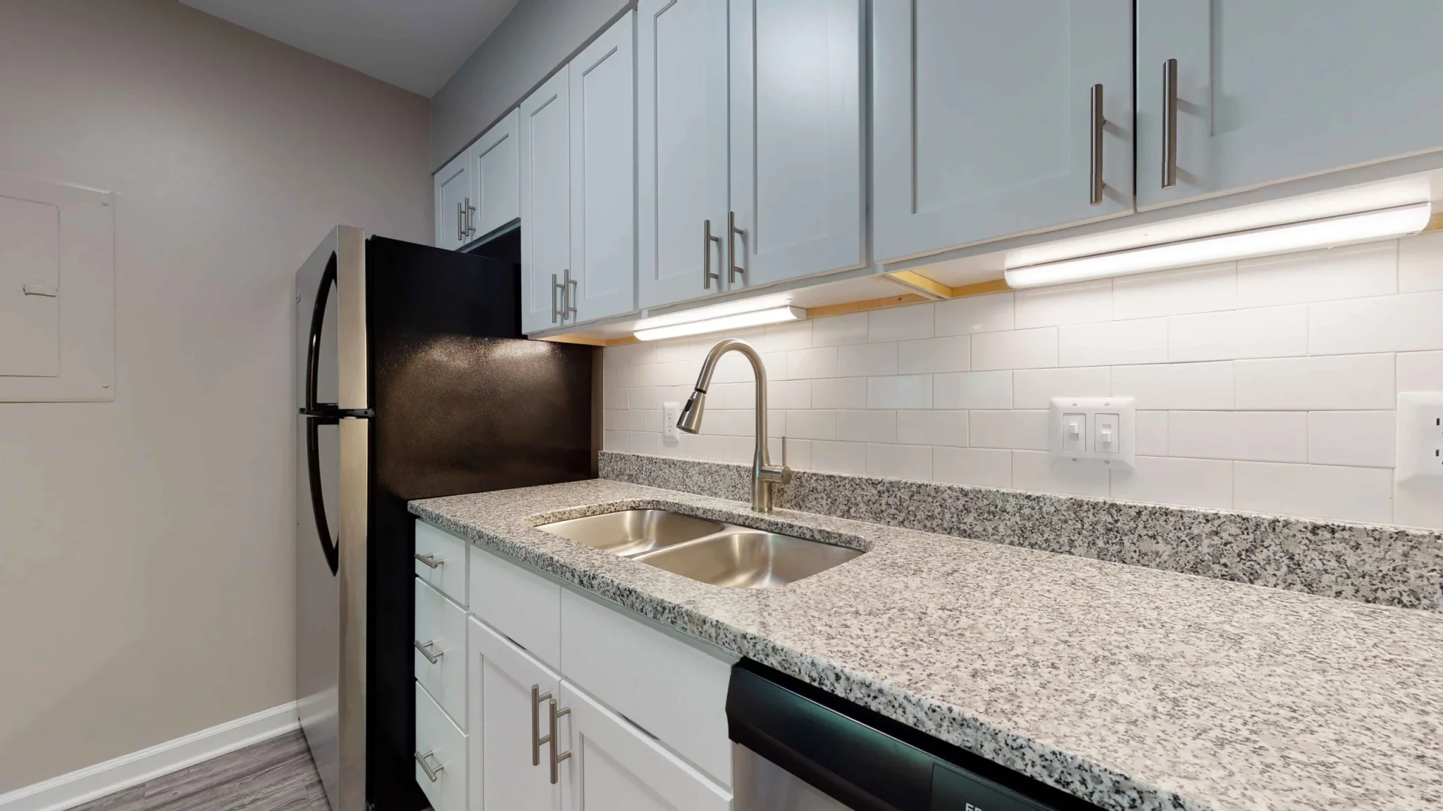 at apartments by NC State 3116 Hillsborough raleigh north carolina vacant unit kitchen granite countertops tile backsplash stainless steel appliances
