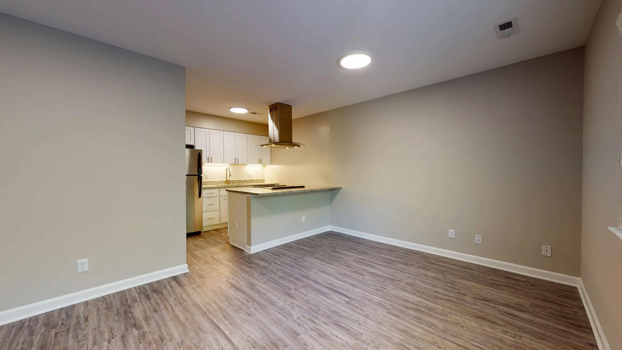at apartments by NC State 3116 Hillsborough raleigh north carolina vacant unit living room and kitchen plank flooring