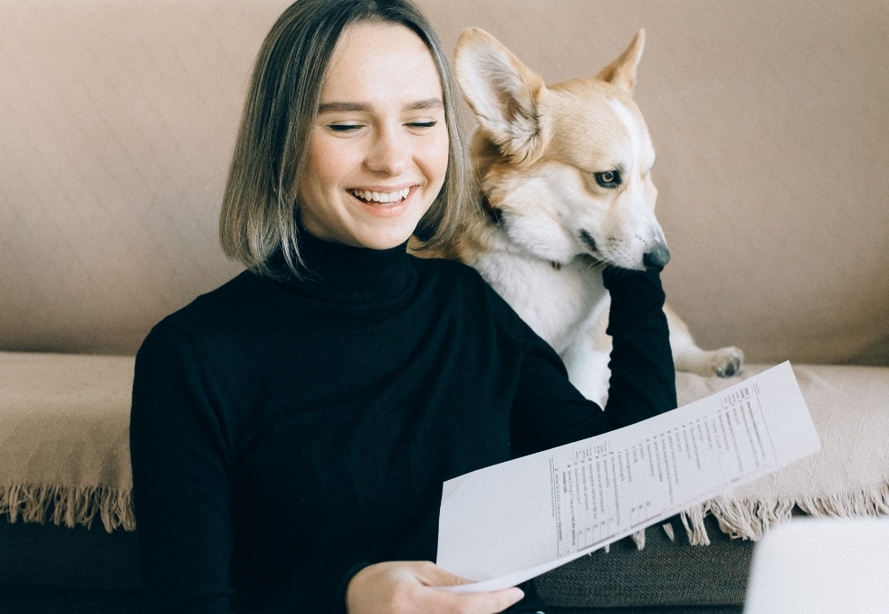 person and dog looking at a piece of paper near apartments by NC State 3116 Hillsborough